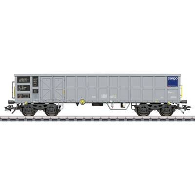 Grey goods wagon with 'cargo' logo on the side, standing on railway tracks.