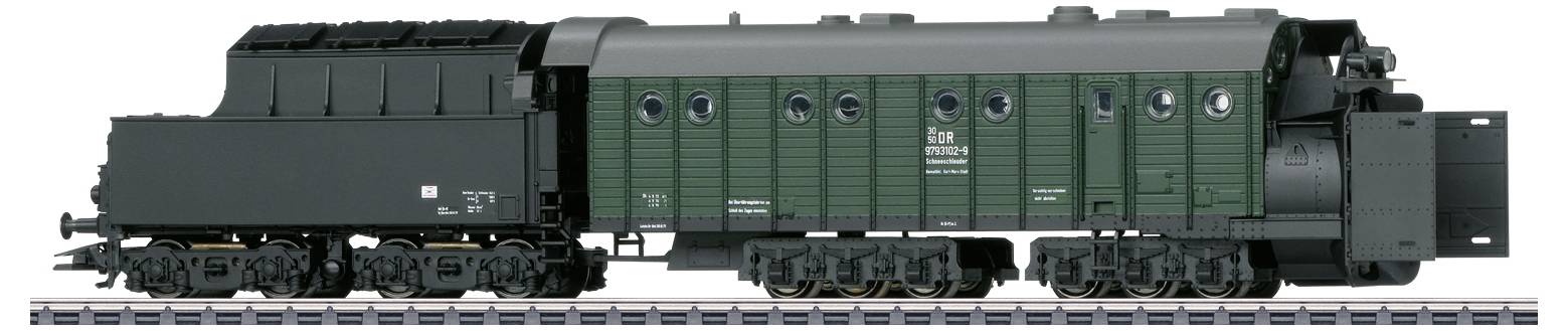 A steam locomotive tender in green and black stands on tracks. It is equipped with eight wheel sets and has a box-shaped construction.
