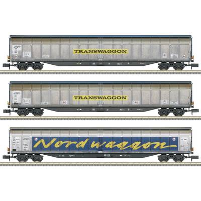 'Three goods wagons, each with inscriptions: top and middle "TRANSWAGGON" in yellow, bottom "Nordwaggon" in blue.'
