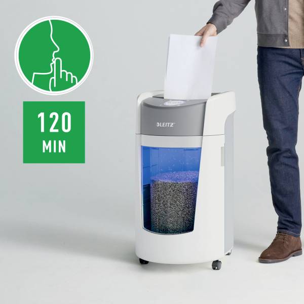 A man is feeding a paper shredder with documents. The device is suitable for continuous operation of up to 120 minutes.