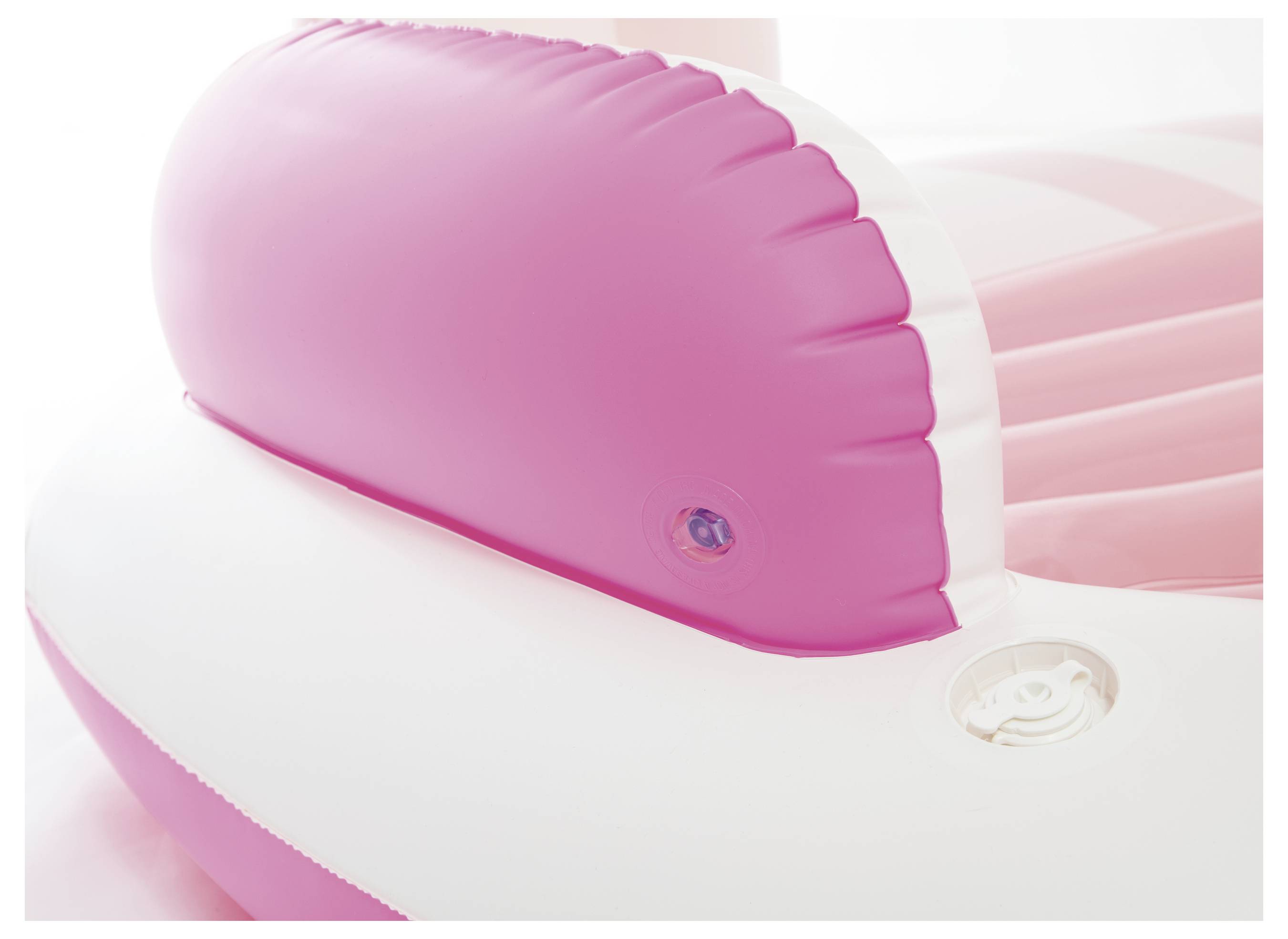 A pink and white inflatable object, most likely a swimming ring or an air mattress, in close-up.
