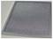 A rectangular, silver air filter with a fine-mesh grid on a light surface.