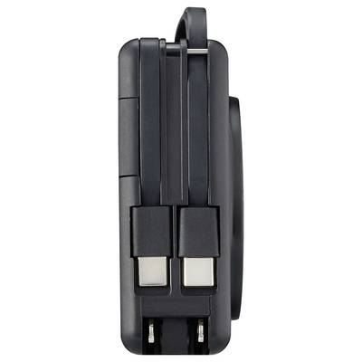 Black compact adapter with two USB ports and foldable plug, suitable for mobile device charging.