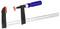 Metal clamp with a blue handle and black mounting brackets, used for holding workpieces.
