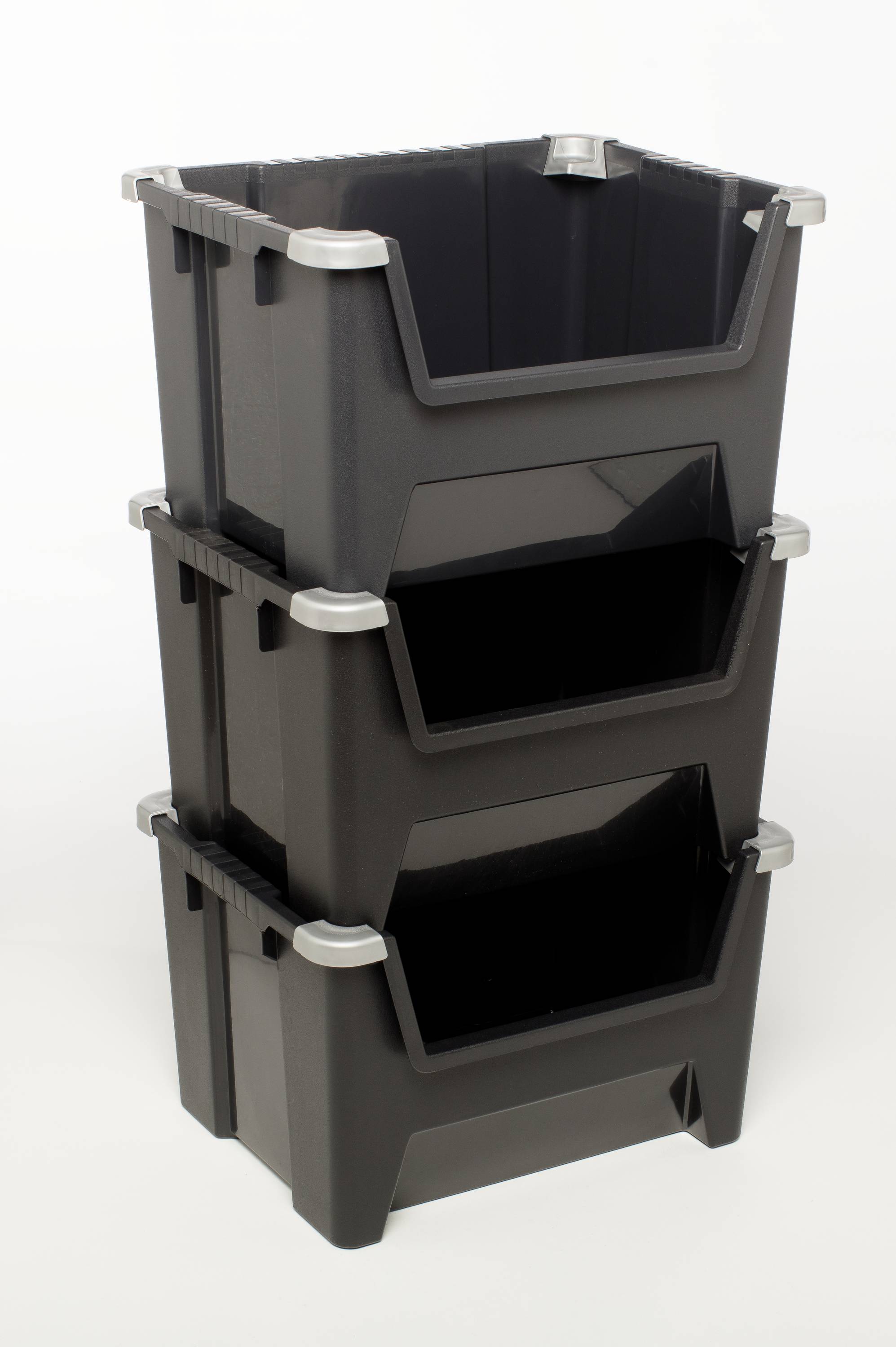 Three black plastic storage boxes with open fronts, stacked on top of each other.
