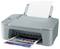 A grey Canon printer with a printed sheet being ejected while another sheet is being loaded.