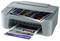 A grey Canon printer printing coloured documents with images of New York City.