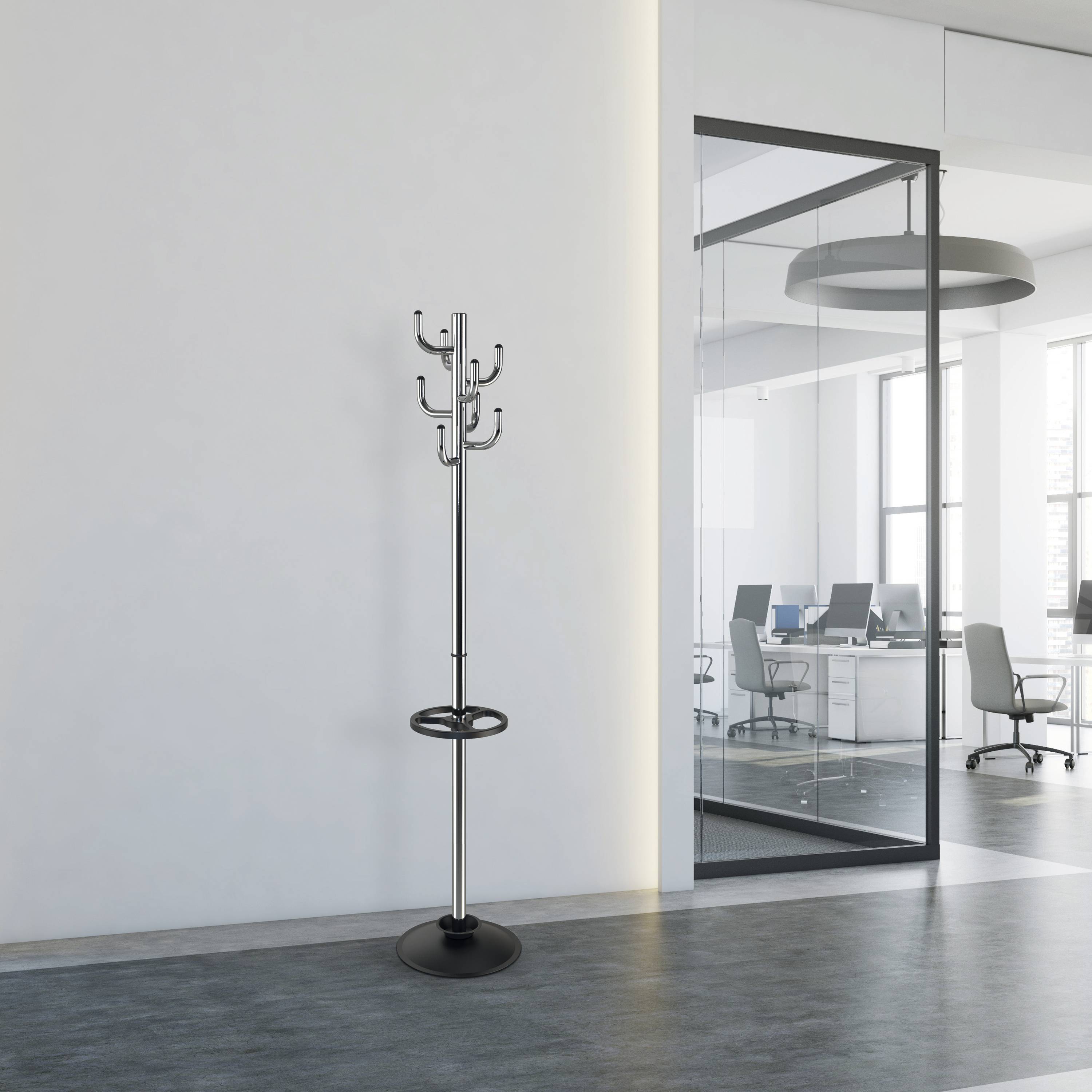 An empty office corridor with a coat stand to the left. Through glass walls on the right, you can see into a modern office with desks and chairs.