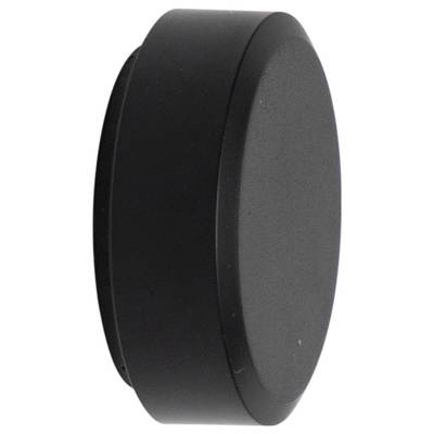 Black ice hockey puck standing upright, viewed from the side, against a white background.