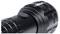 Close-up of a black torch head with a side switch and textured grip.