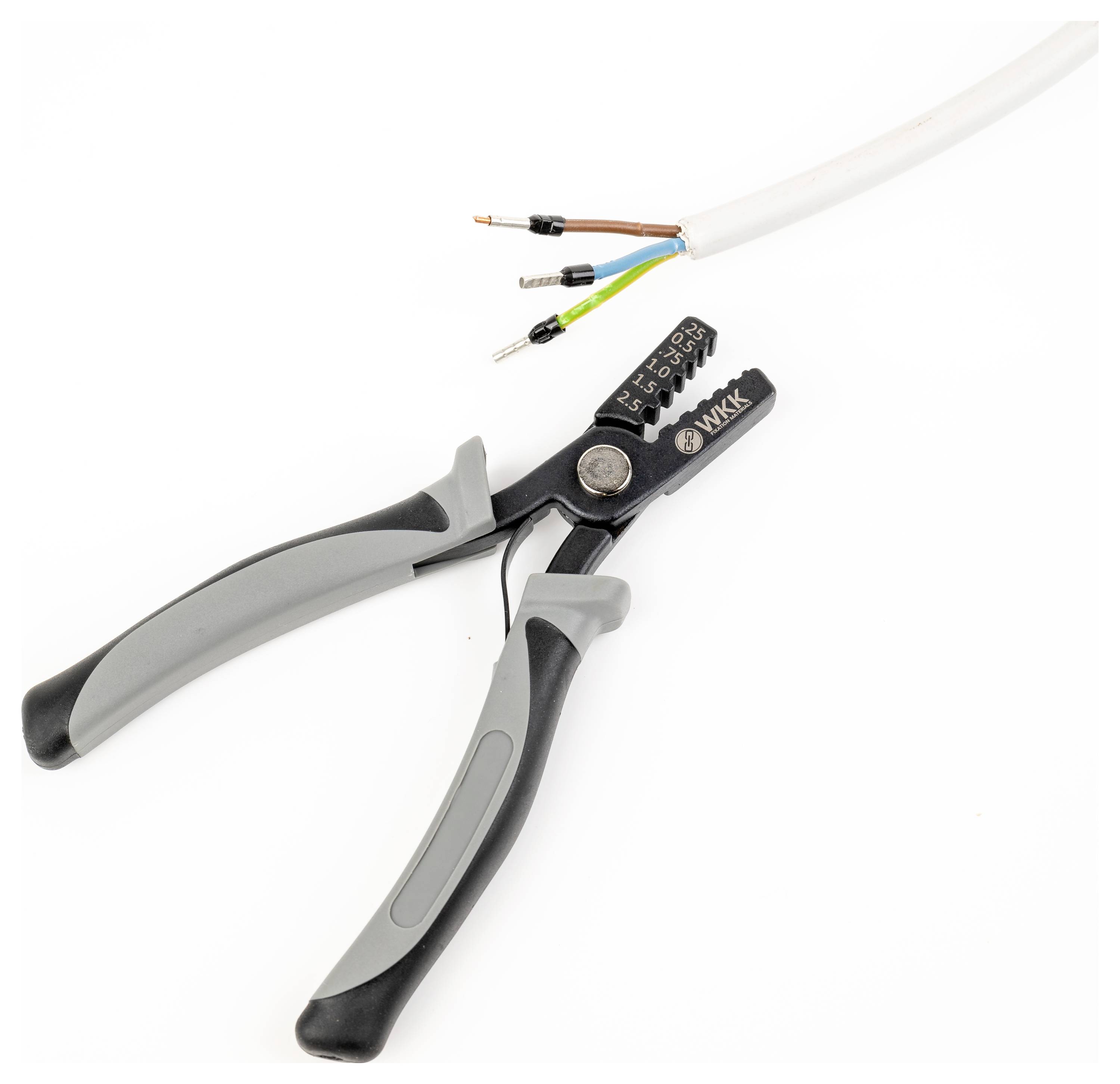 Wire cutters with grey handles are cutting a cable with exposed wires in various colours.