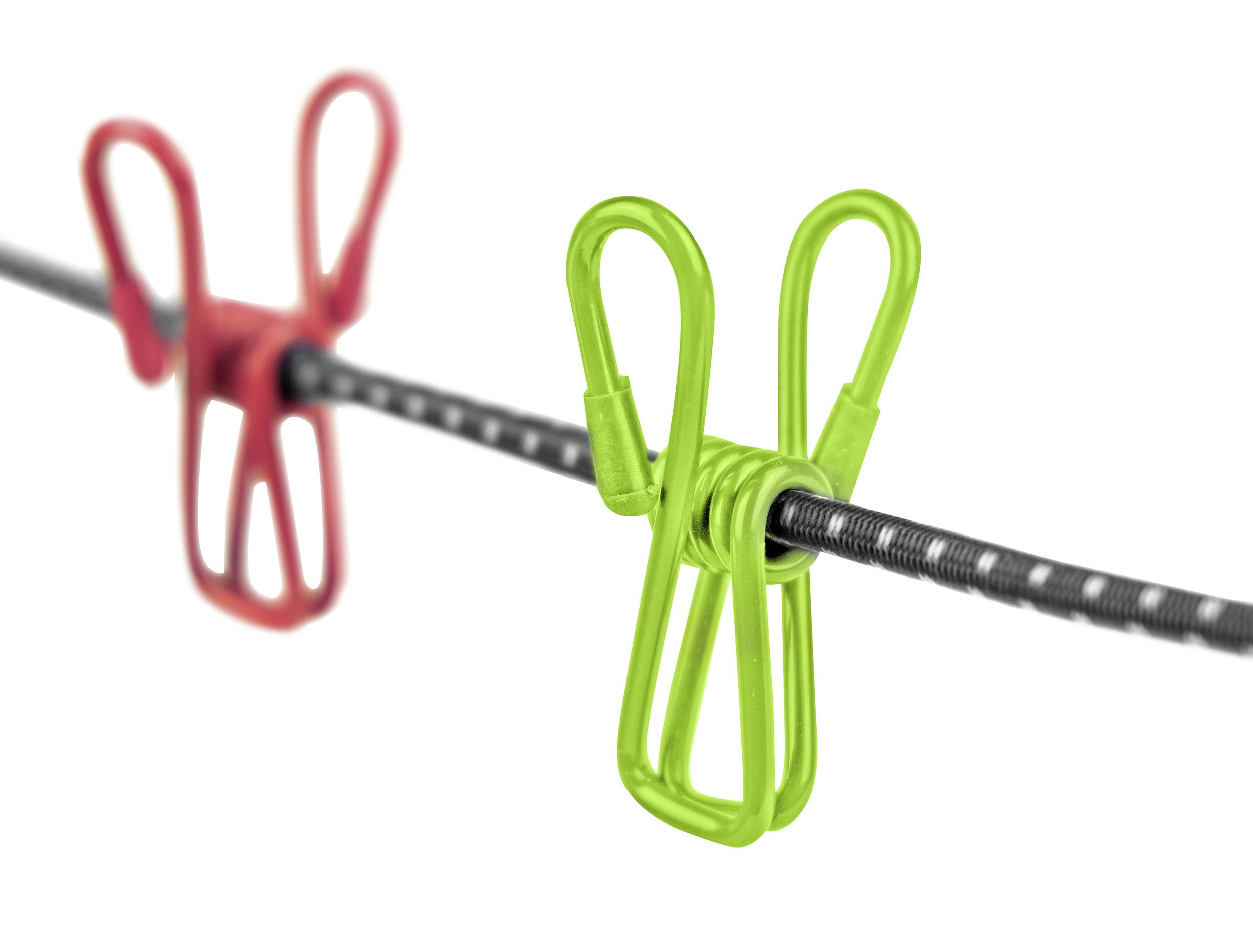 Two coloured clothes pegs, red and green, hang on a stretched washing line. The focus is on the green peg in the foreground.
