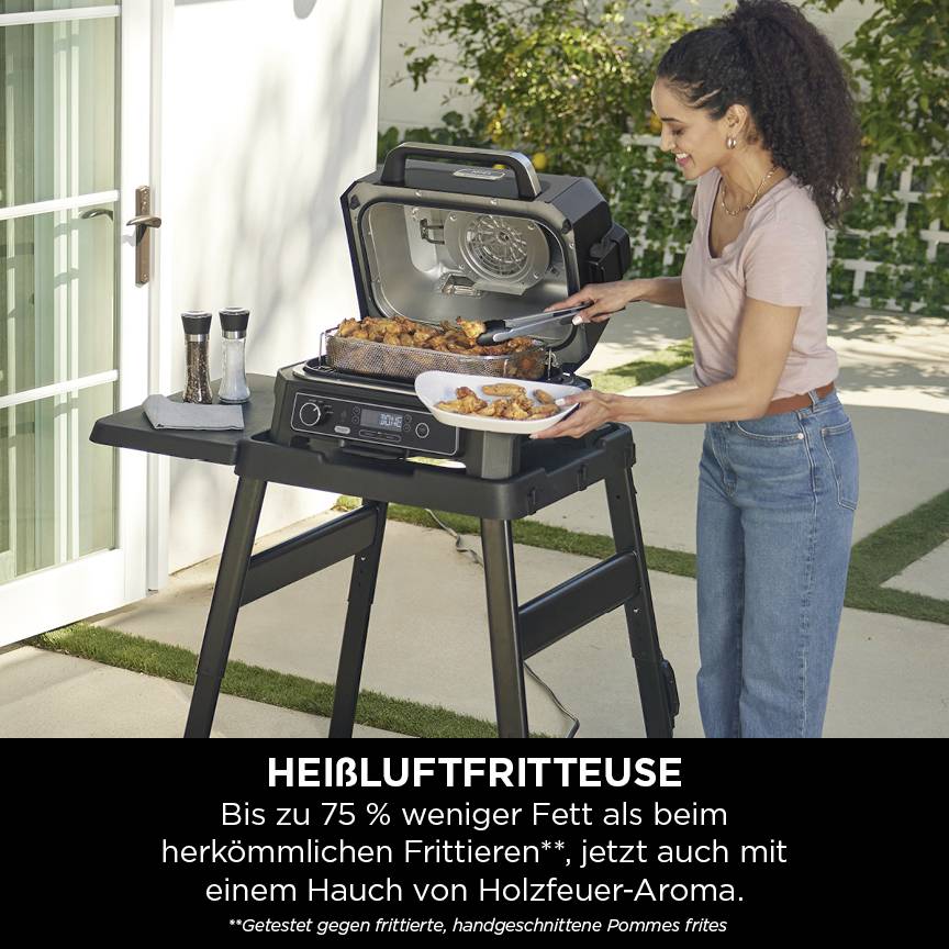 A woman is grilling chicken wings in an air fryer on an outdoor table. Underneath it reads: 'Up to 75% less fat'.