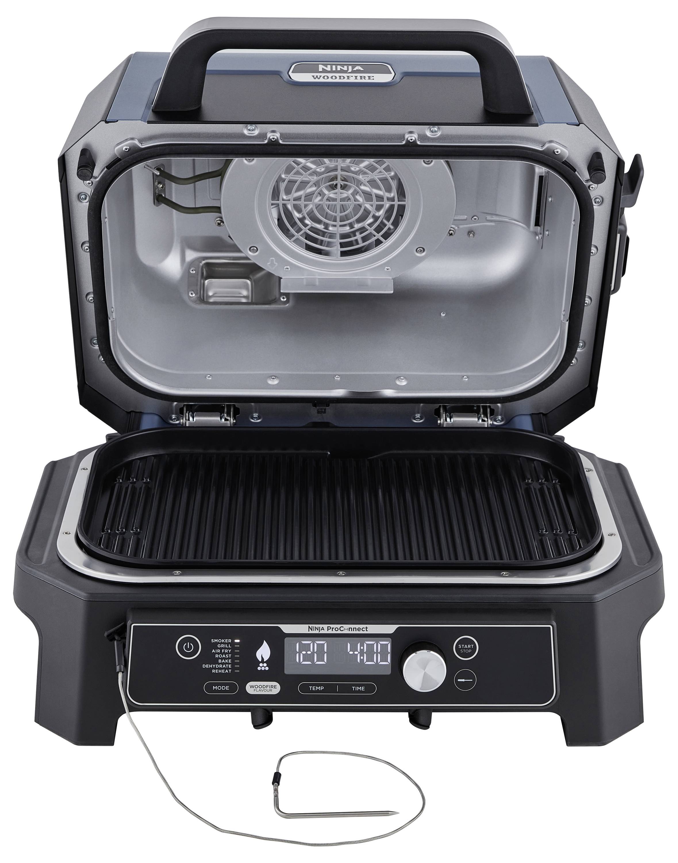 An open electric barbecue with a view of the grill grate and control panel. A cable thermometer is hanging out at the front.