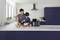 A man and a child are baking together in a modern kitchen. An air fryer sits on the worktop.