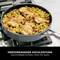 A pan with a rice dish and chicken pieces on a hob. Underneath the text reads 'Outstanding Cooking Performance - Even Heating, Without Hot Spots'.