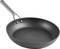Black frying pan with a silver handle, made from non-stick material, on a white background. Suitable for preparing various dishes.