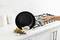 A hand tilts a pan, sliding a fried egg onto a plate of potatoes and sausages in a modern kitchen.