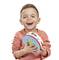 A laughing child is holding a colourful tambourine. The boy is wearing an orange top and is looking directly at the camera.