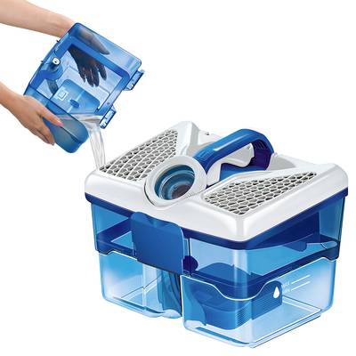 A person is pouring water into a blue water filter container with a carrying handle and a mesh lid, which is being prepared for use.