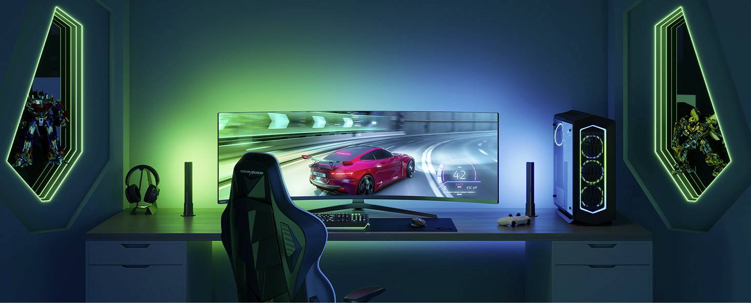 A gaming setup with a curved monitor, displaying a racing game. Coloured LED lighting surrounds the desk and PC.