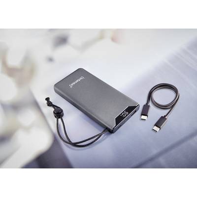A portable power bank with LED display and cable, lying on a table. The capacity is shown on the display.