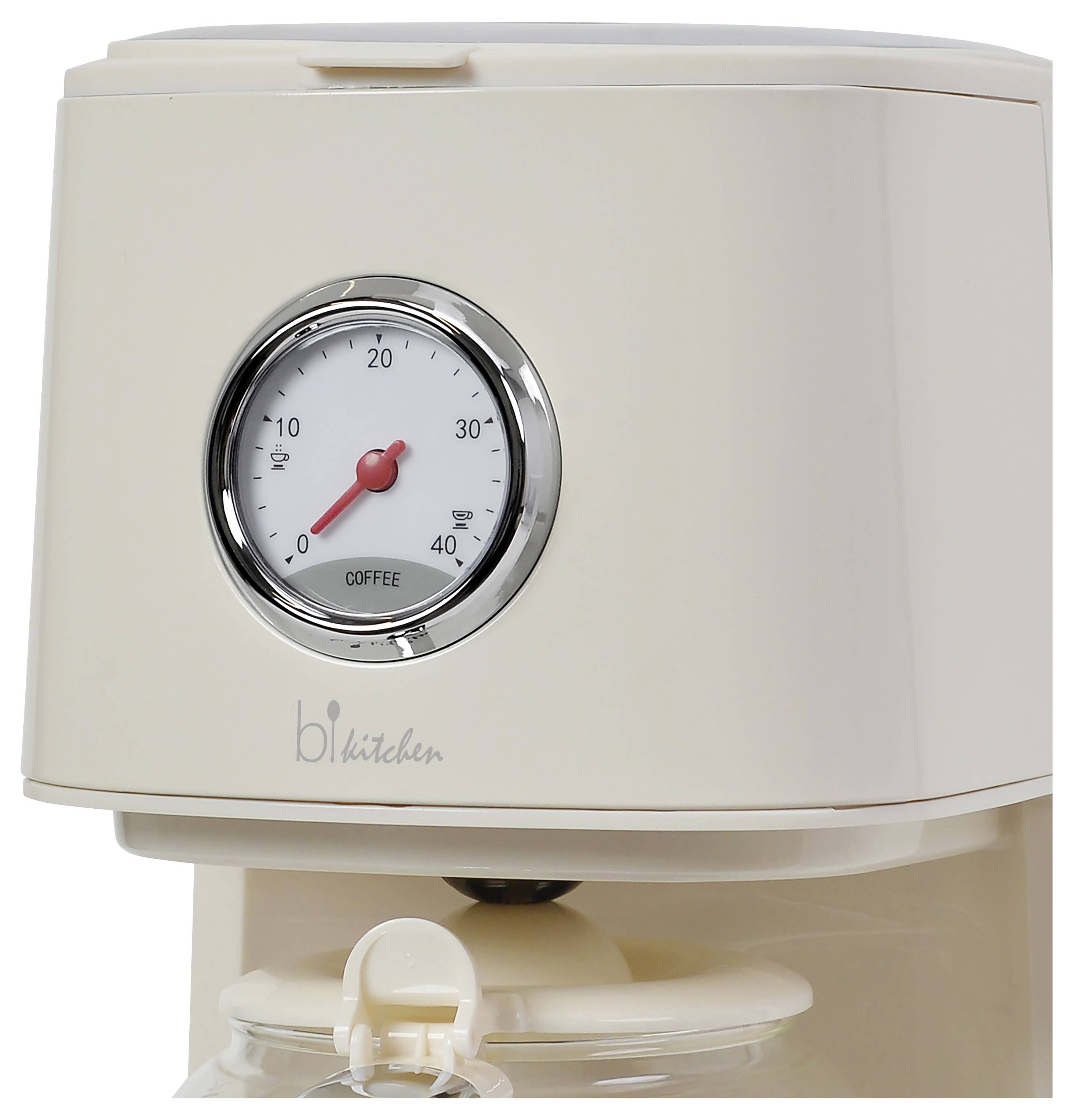 A cream-coloured coffee machine with an analogue thermometer on the front displays the temperature in degrees Celsius.