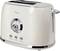 A cream-coloured toaster with a dial, three buttons for 'Defrost', 'Reheat' and 'Cancel', and a lever on the side.