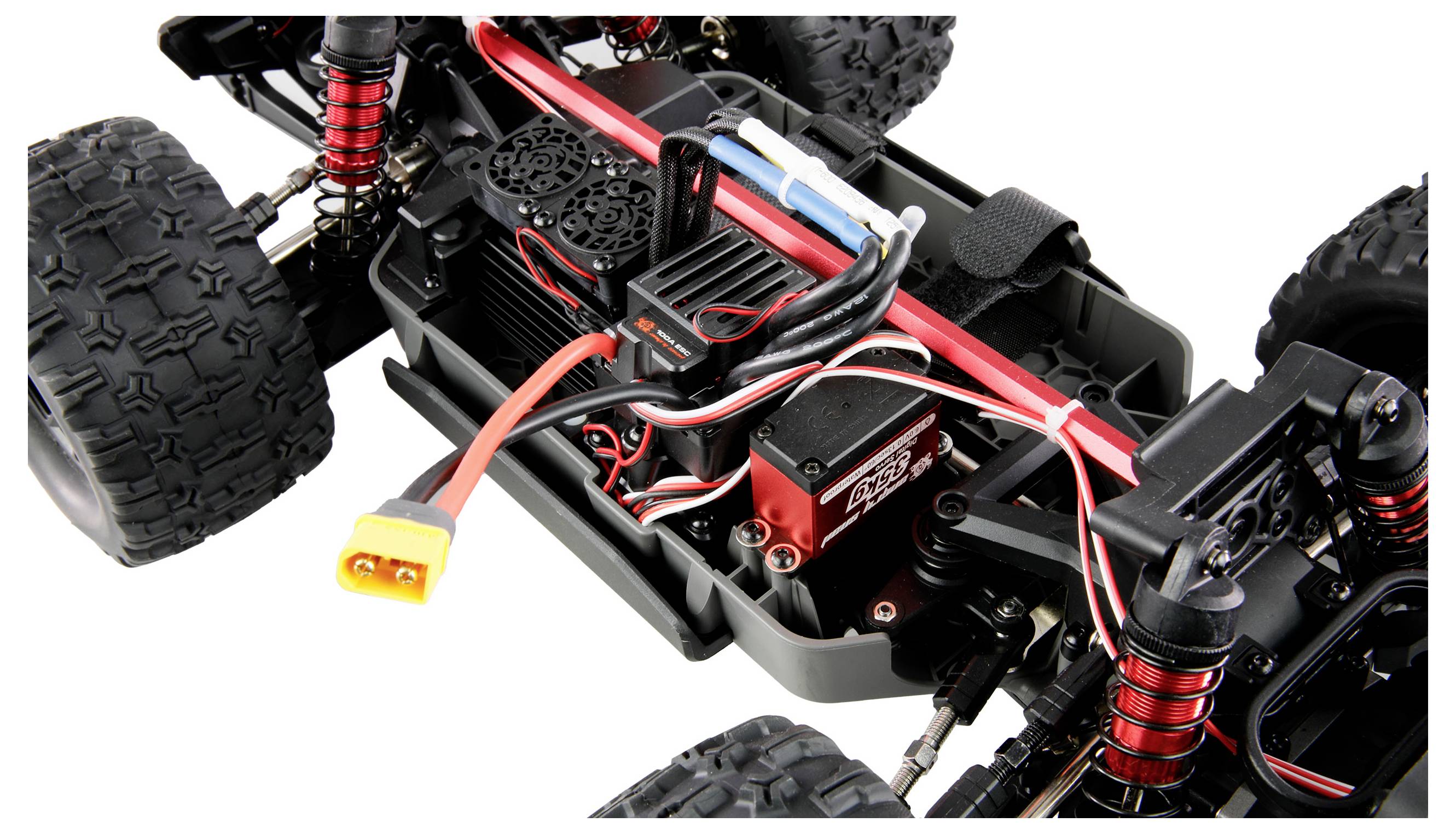 Close-up of a remote-controlled car showing the engine, electronics, and wiring. The chassis is visible.