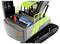 Green and grey toy digger with an open engine compartment, revealing a battery and cables. Driver figure visible in the cab.