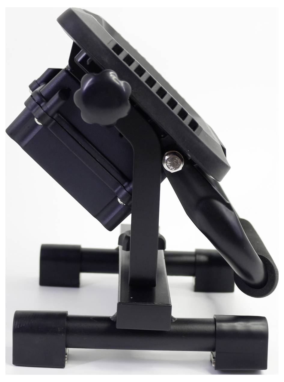 Floodlight viewed from the side, mounted on an adjustable stand. The light is housed in a black casing.