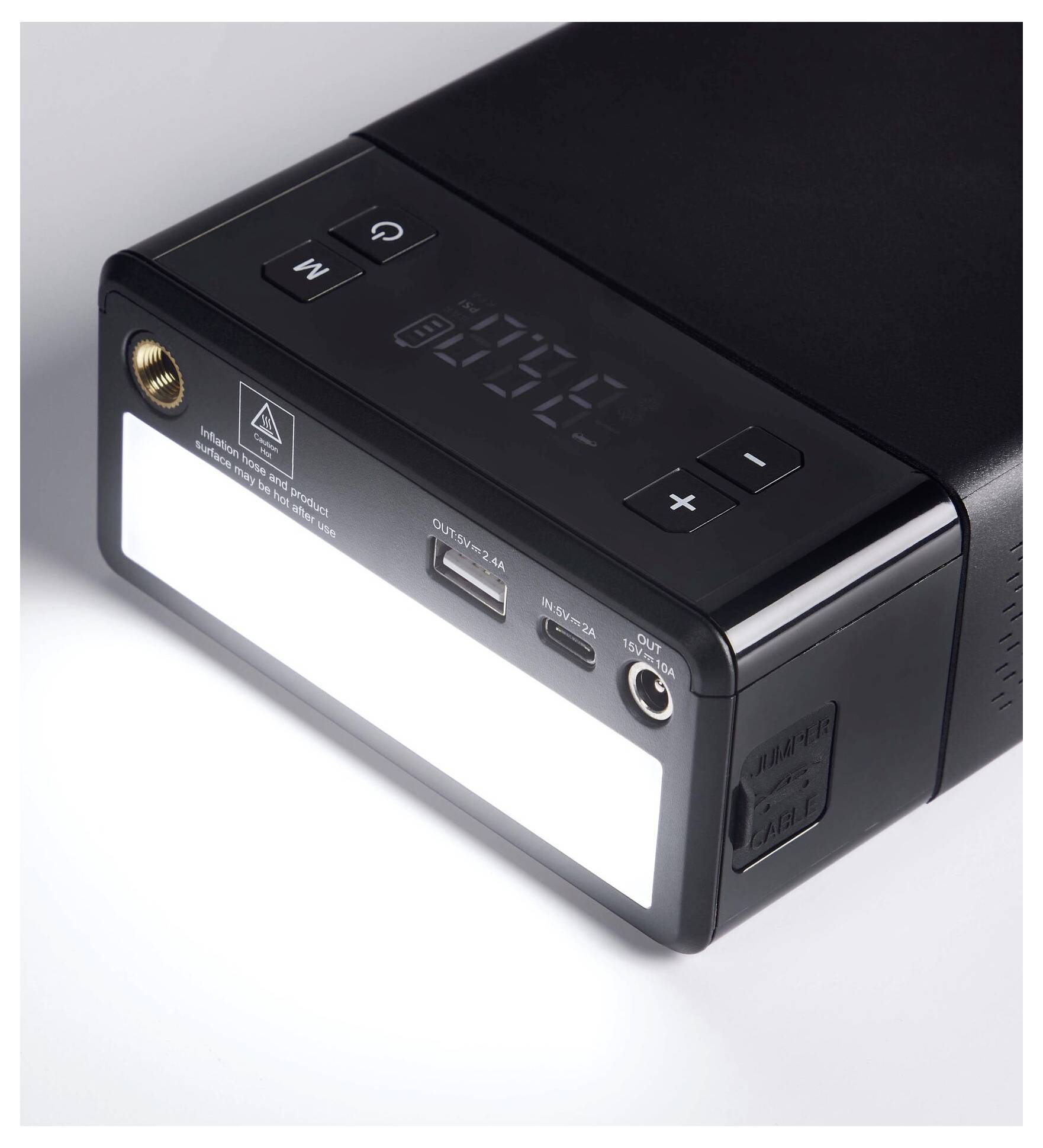 A black electronic device with a display, buttons, and multiple ports, including USB and DC Out, on a white surface.