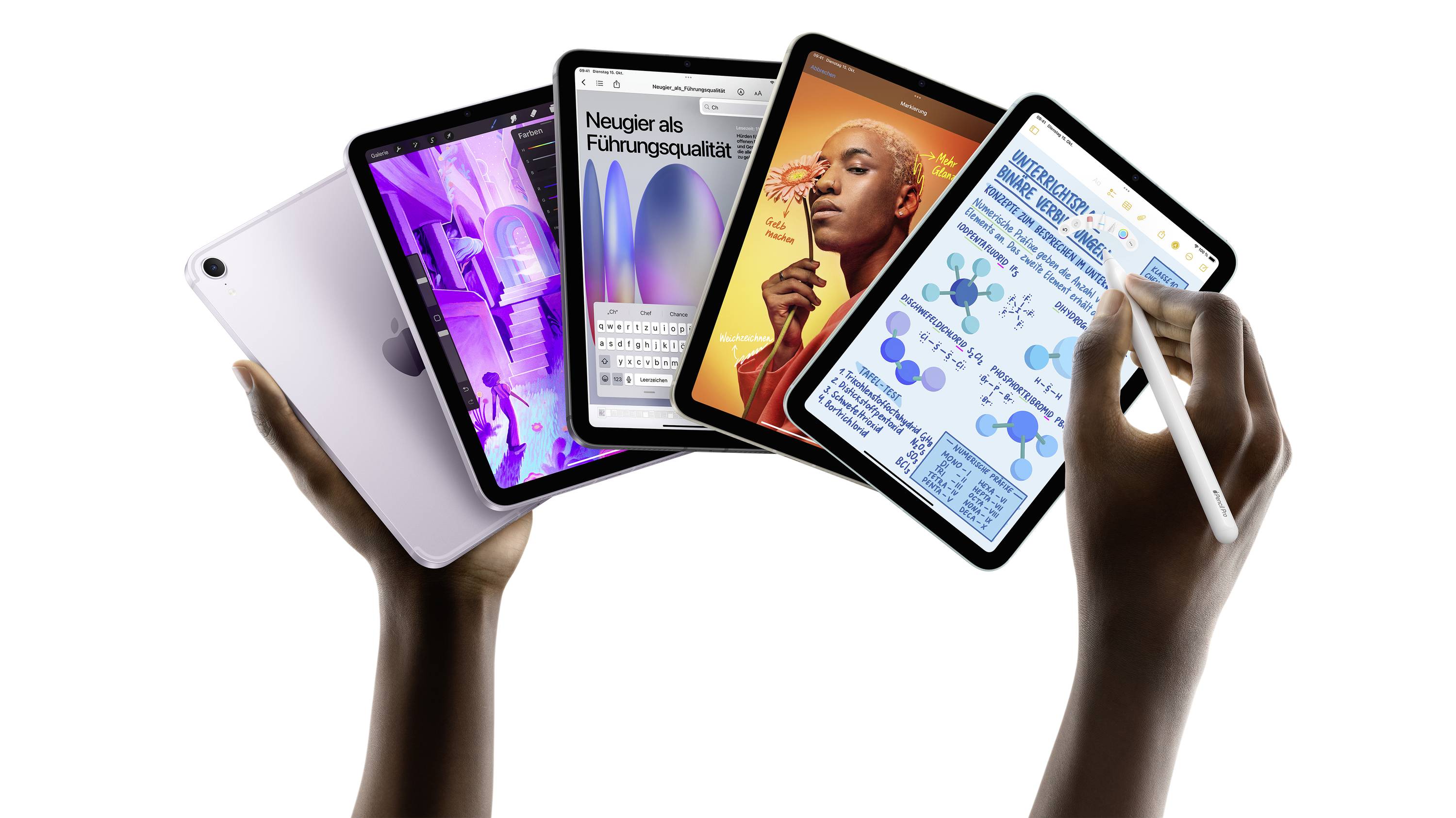 Two hands are holding several tablets. On the screens are various apps: a word processor, a graphics program, a sketch, and a note-taking application.