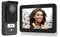 Video doorbell with display shows smiling woman outdoors; device by Philips, named 'Baker Family'. Integration of surveillance and communication.