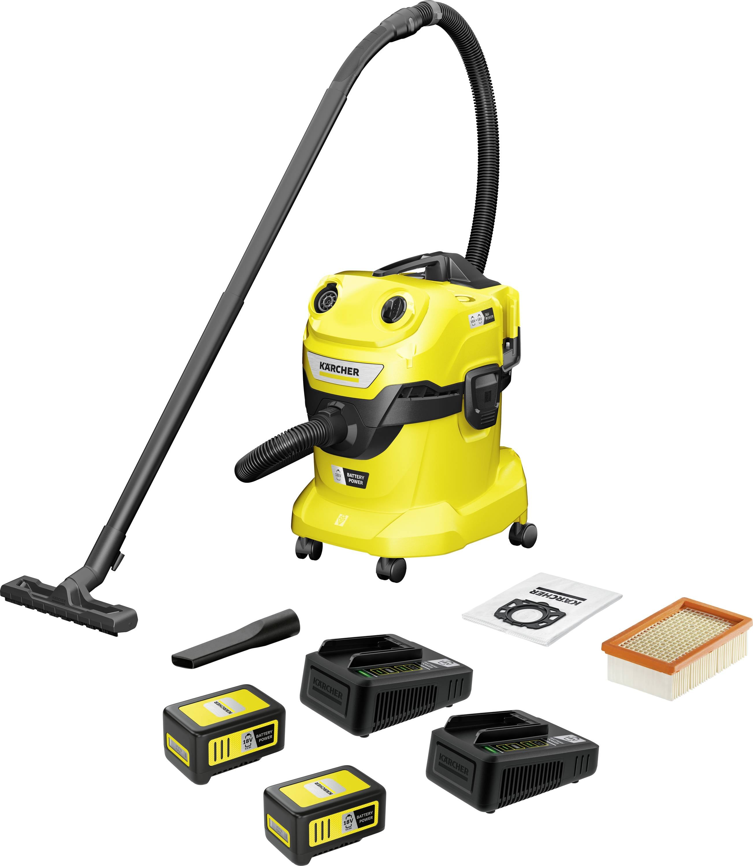 Yellow industrial vacuum cleaner with accessories: two batteries, two chargers, filter, and bags, ready for cleaning work.