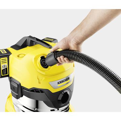 A hand inserts a hose into a yellow vacuum cleaner. The vacuum cleaner has silver and black details and the 'Kärcher' logo.