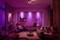 Living room under soft, violet lighting. Modern furniture, cosy atmosphere with sofa, armchair and decorative elements.