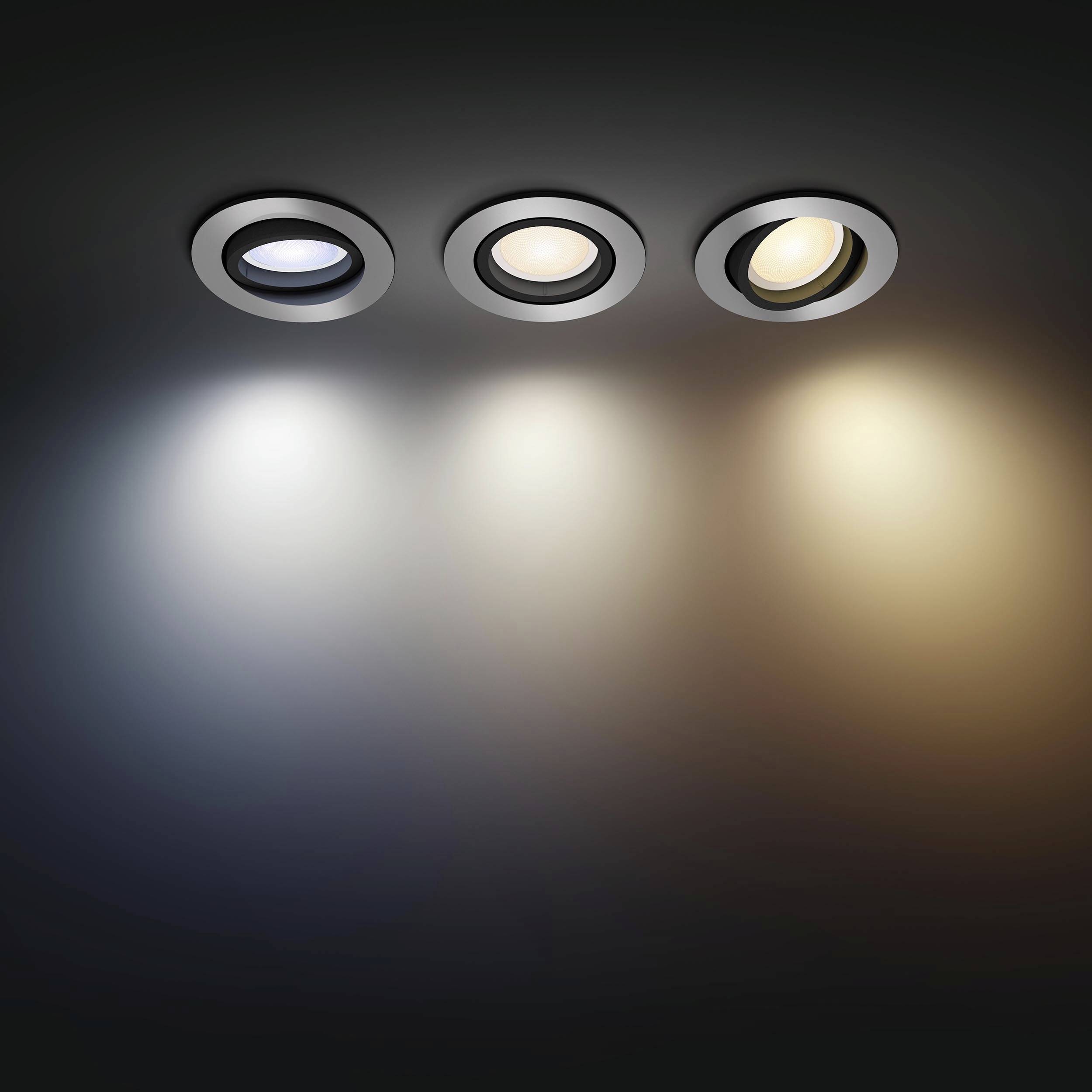 Three recessed lights in a ceiling, each with a different colour temperature: cool white, neutral white, and warm white.
