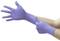 A person is putting on a purple disposable glove on their right hand, with the left glove already being worn.