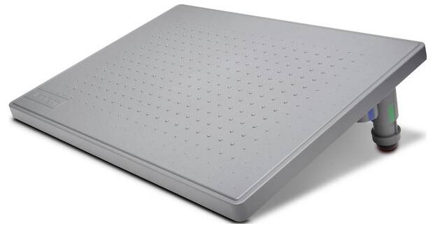 Grey, tilted footrest with a dotted surface and adjustable height, designed for ergonomic comfort in the office.