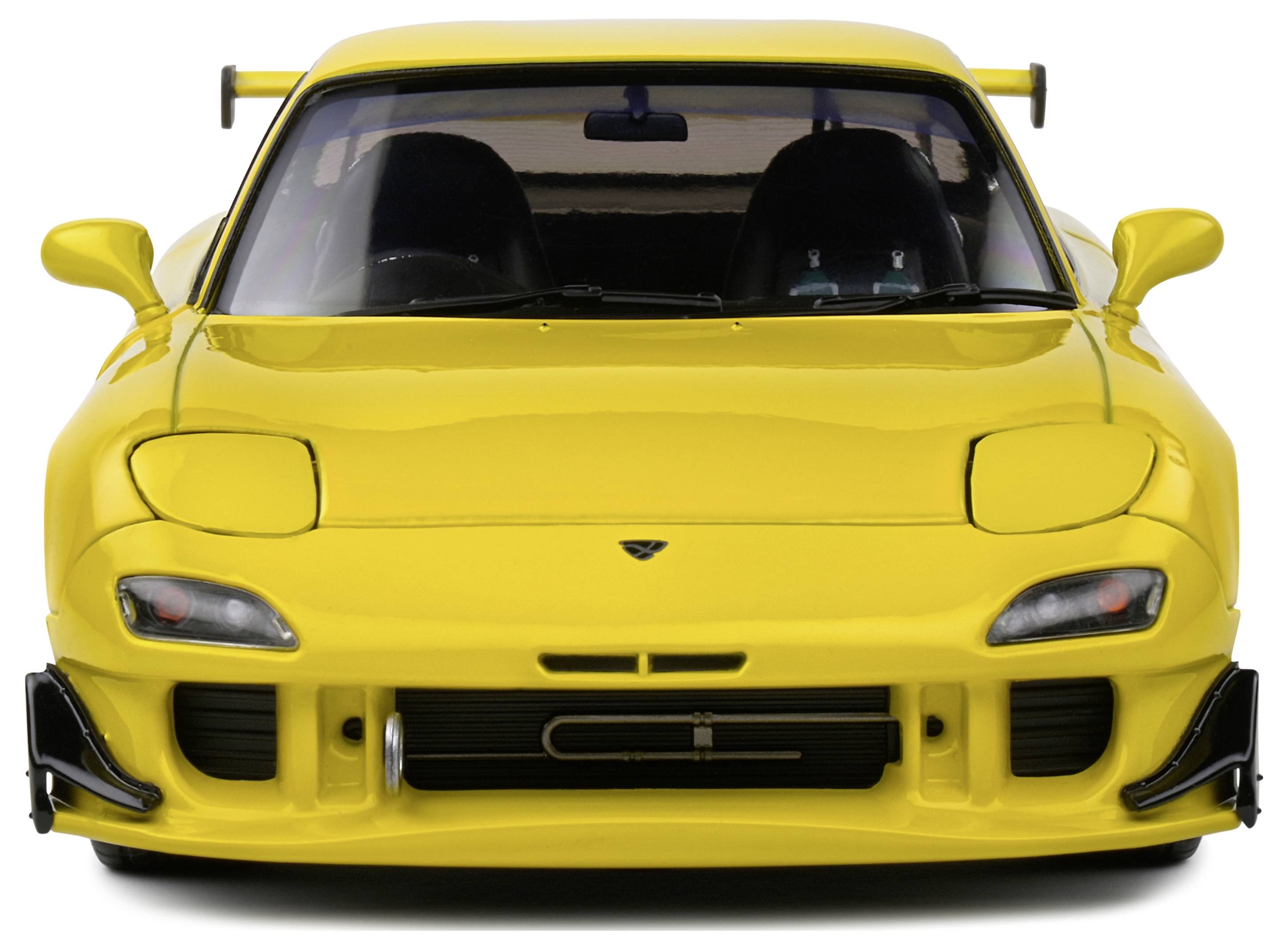 Yellow sports car from the front with aerodynamic design and a spoiler on the boot lid.