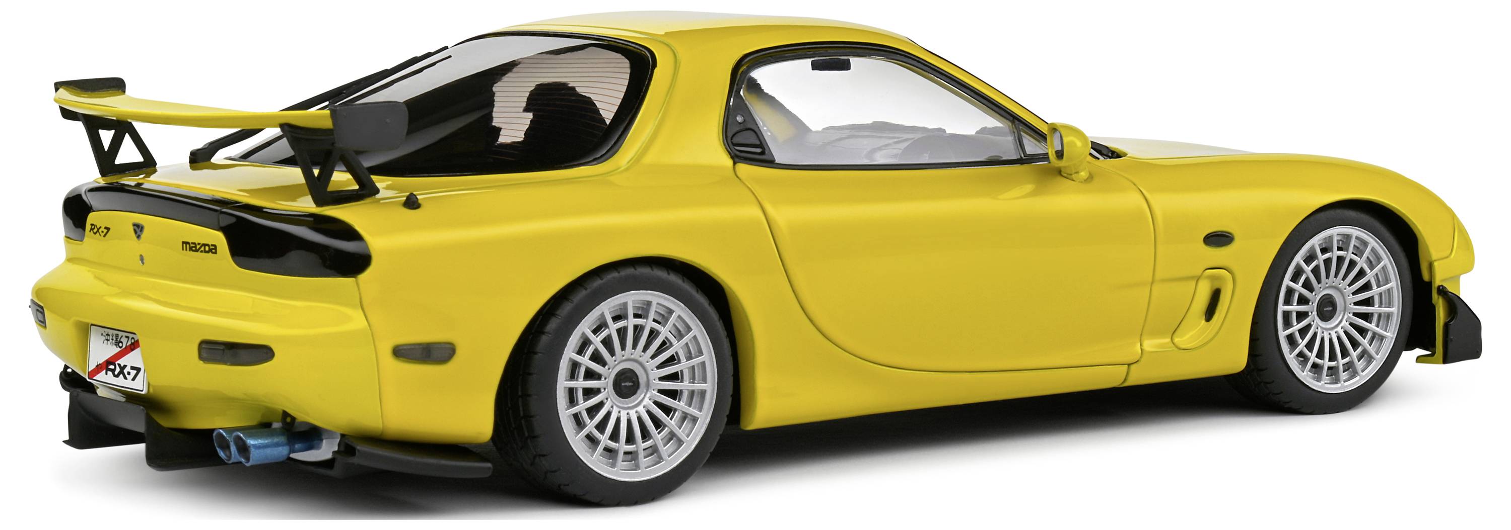 Yellow sports car in side profile, lowered with a prominent rear spoiler, parked state. Sporty design and low-profile tyres visible.