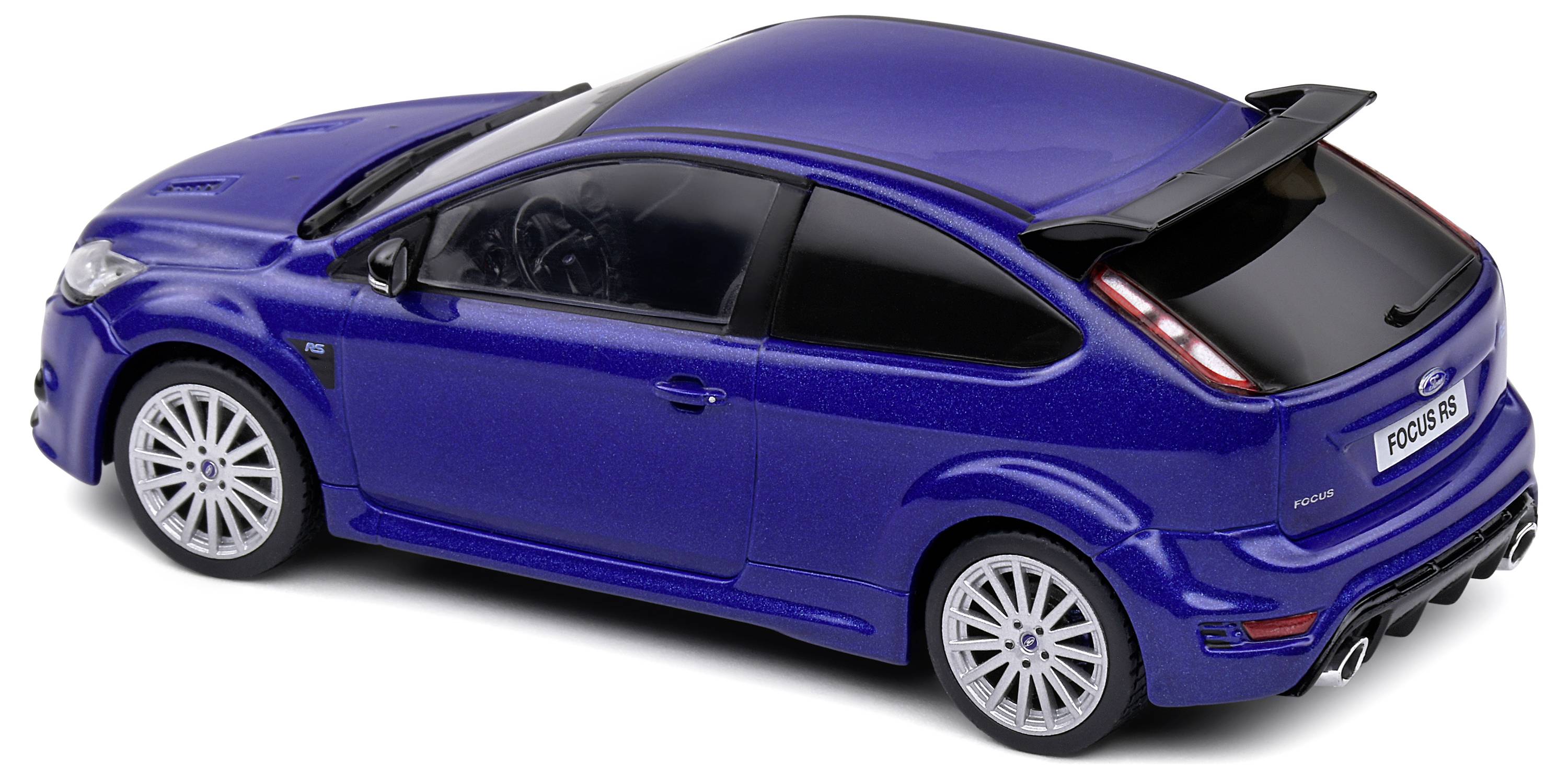 Blue model car of a sporty compact car with a prominent rear spoiler and silver wheels, photographed from a rear three-quarter angle.
