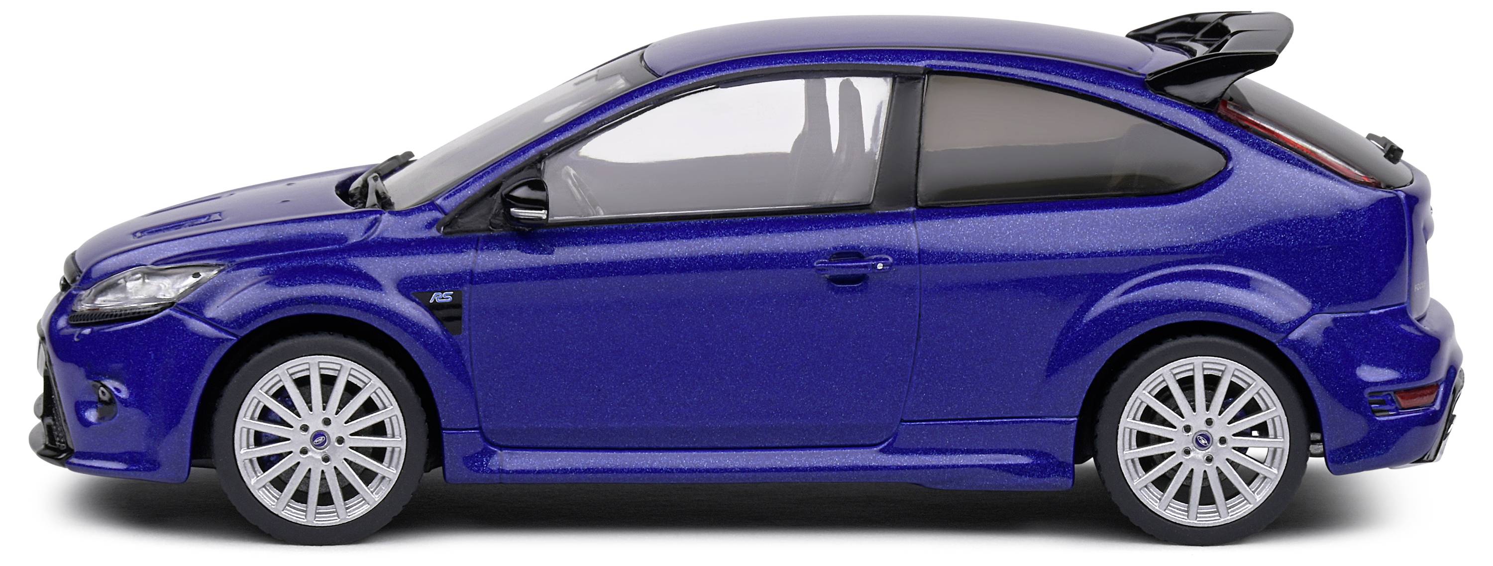 A blue model car, side view, in 1:24 scale, shows a sporty design with distinctive alloy wheels and rear spoiler.