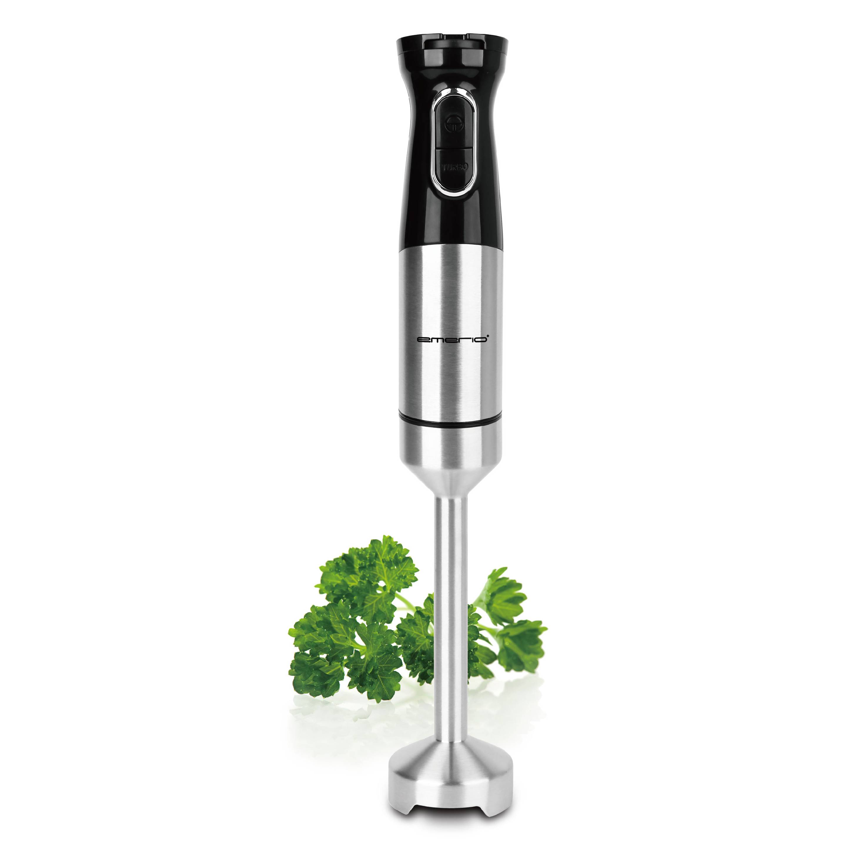 A stainless steel hand blender stands vertically. Fresh parsley leaves are lying beside it.