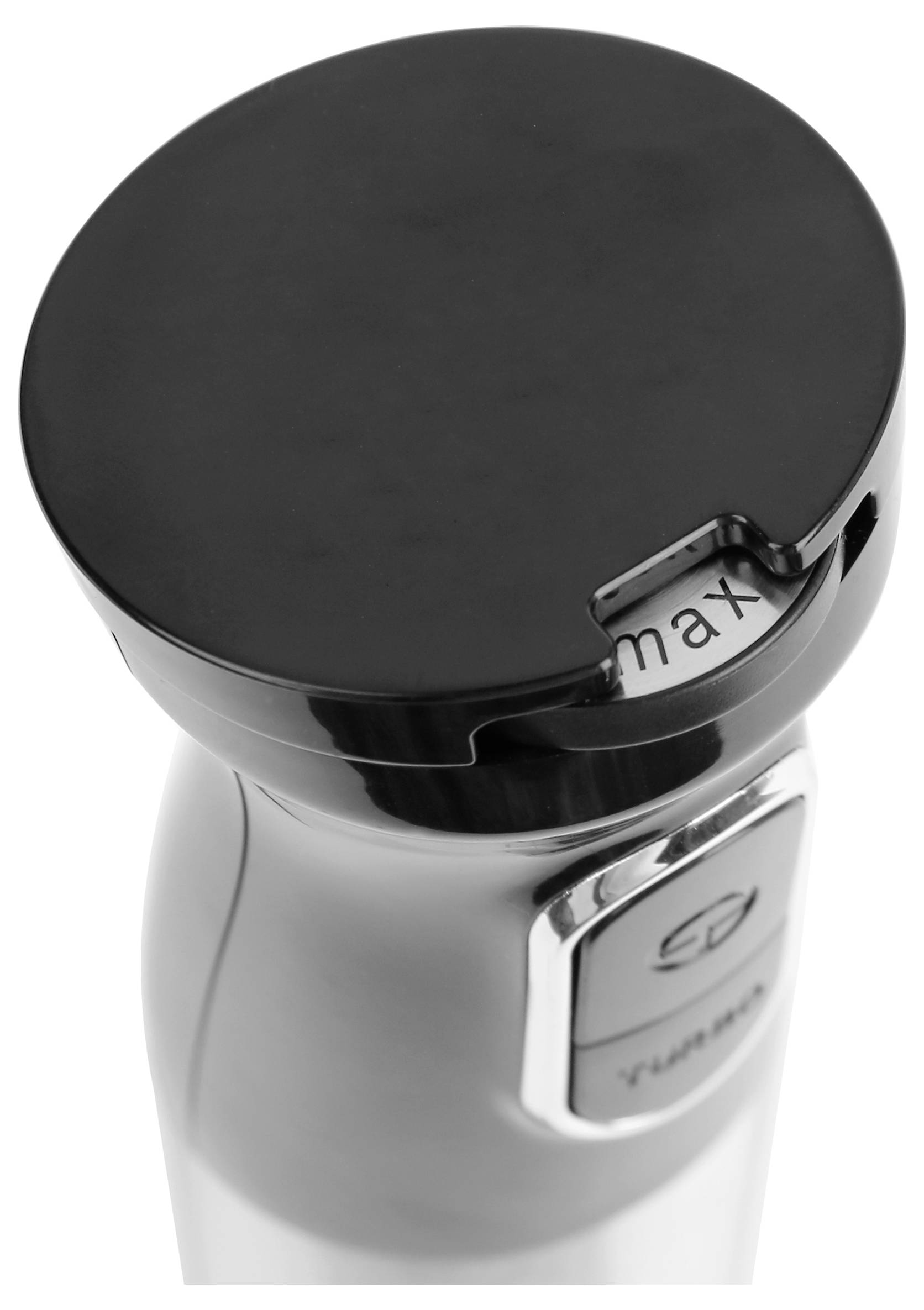View of a white stand mixer from above. The lid is black and a maximum marking is visible.