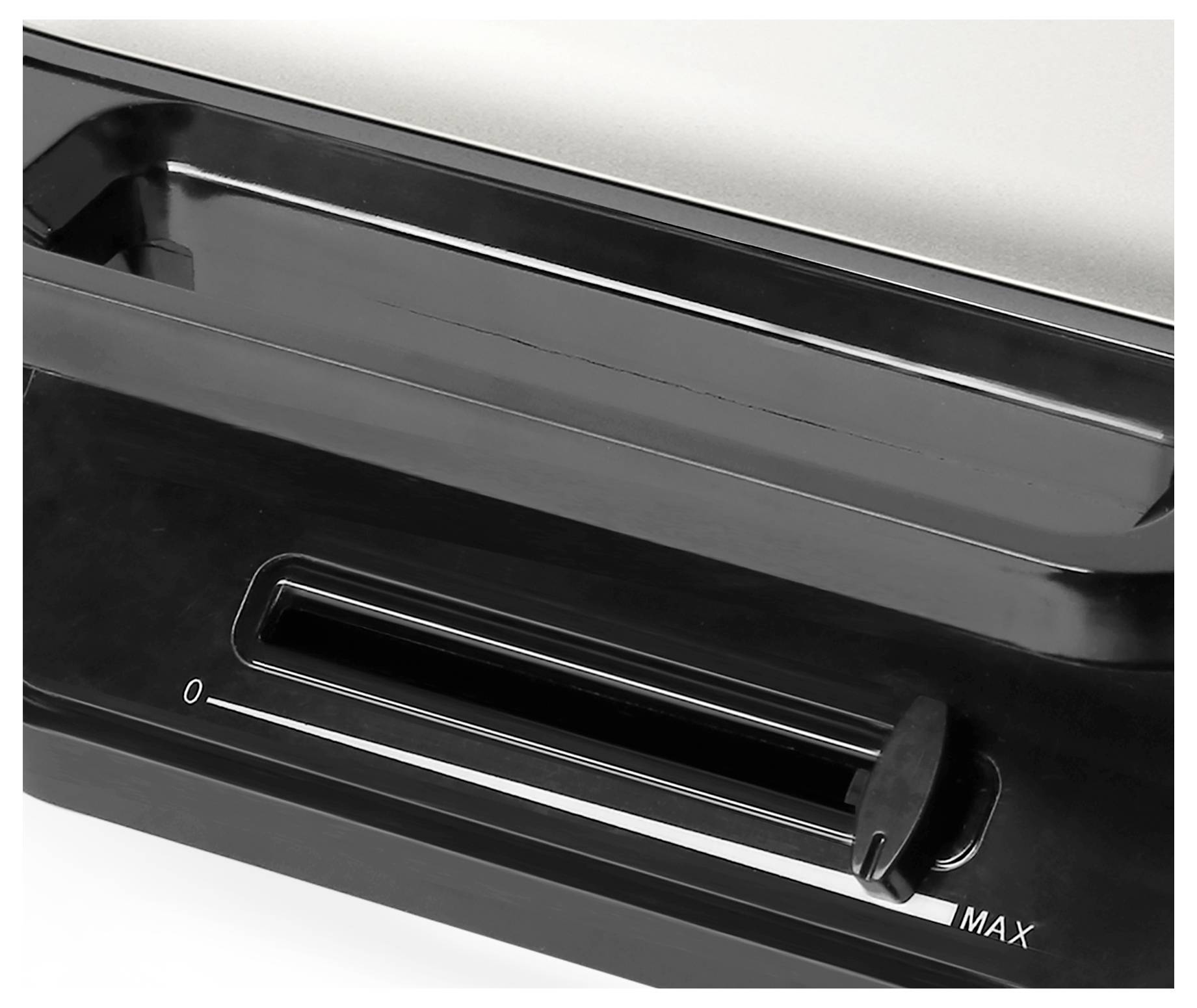 Closed black sliding switch on a device, marked from '0' to 'MAX'.