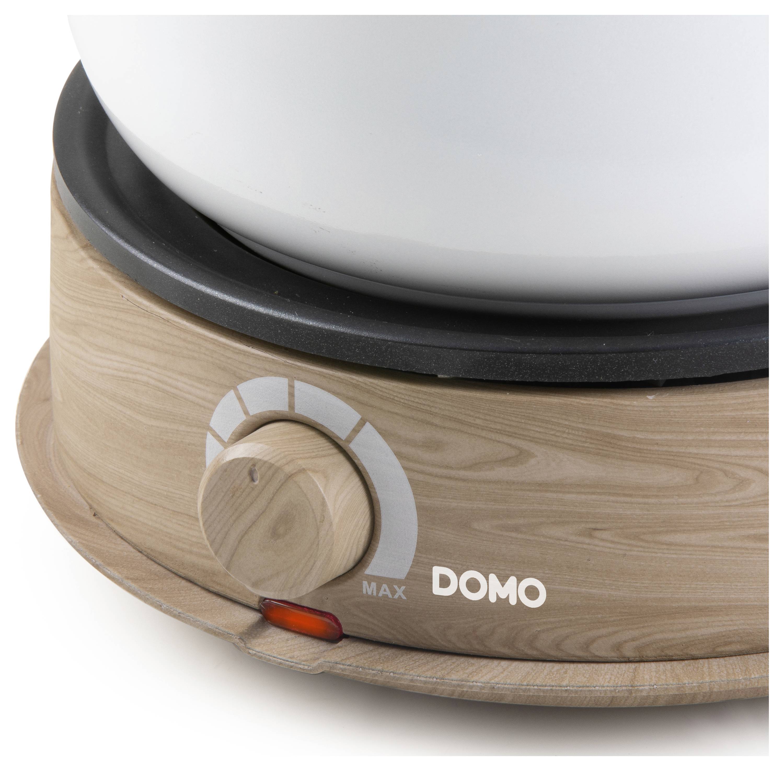 Wooden-coloured base of a device with a rotary dial and 'DOMO' logo; displays temperature indicator with 'MAX' marking.