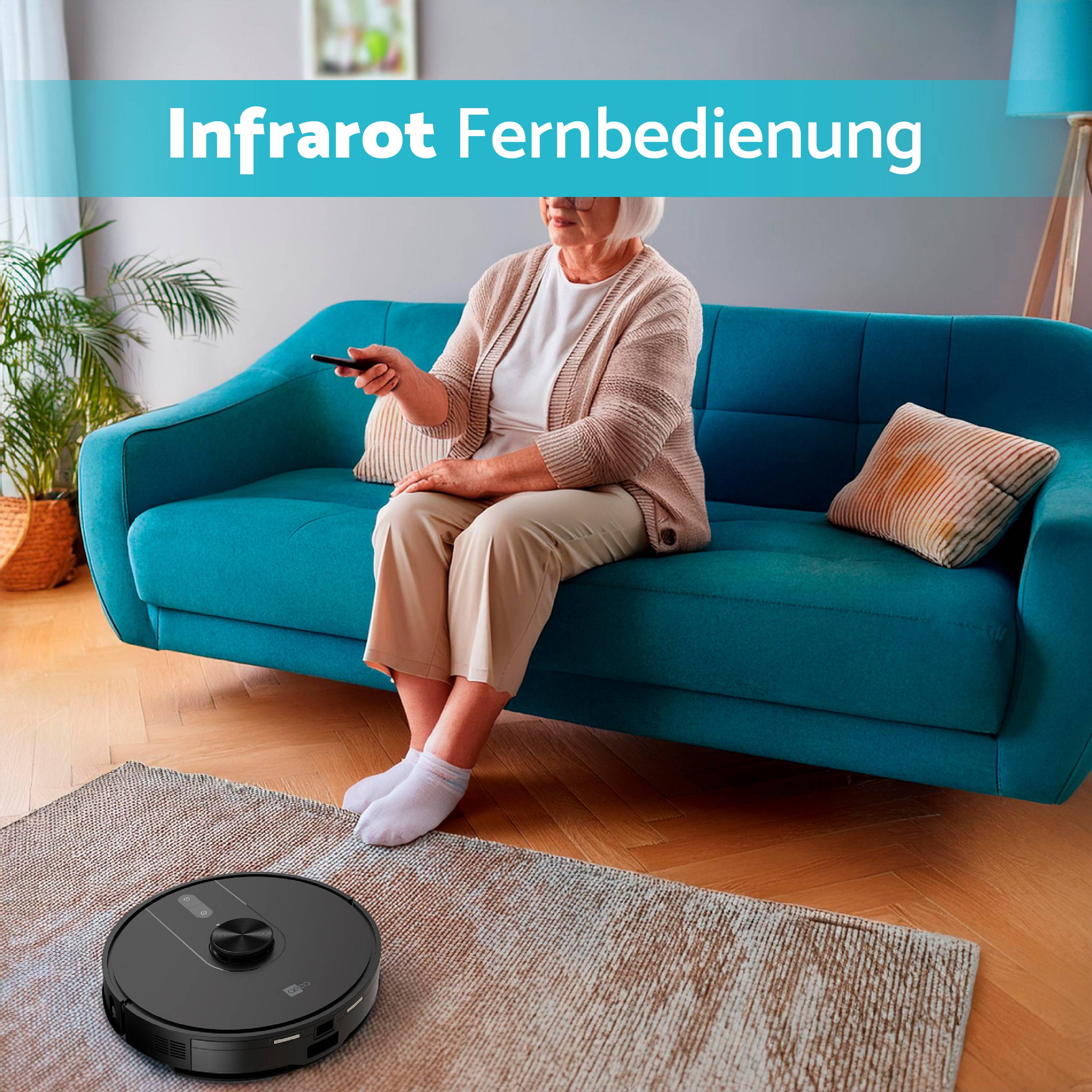 A person is controlling a robotic vacuum cleaner remotely using a remote control while sitting on a blue sofa.