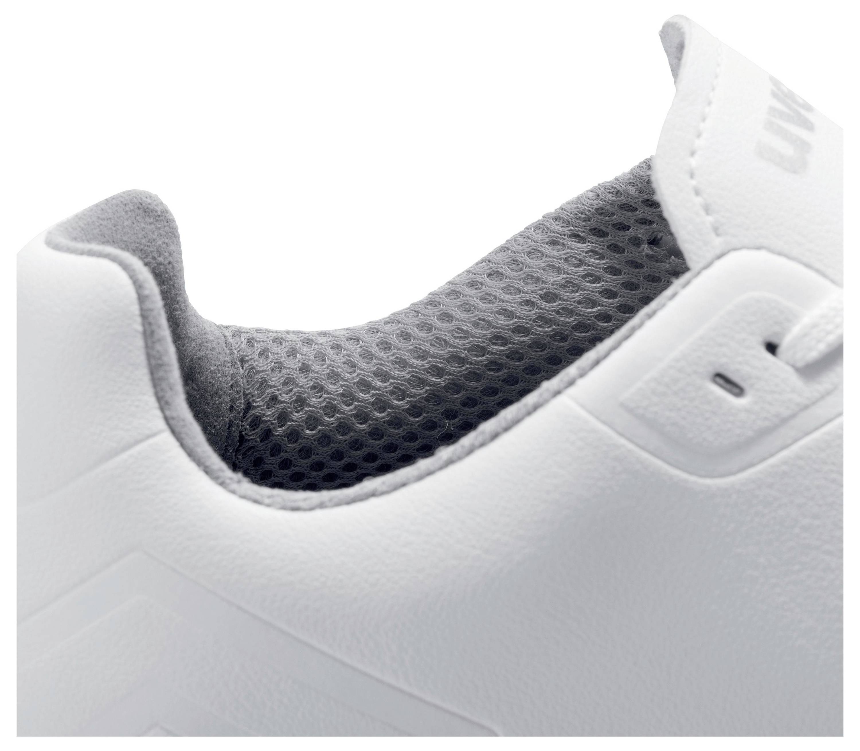 Close-up of a white trainer showing the padded, grey interior of the shoe; focus is on material texture.